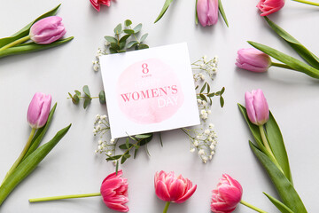 Greeting card with gypsophila flowers and beautiful tulips on grey background. International...