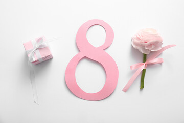 Figure 8 made of paper with gift box and beautiful peony flower on white background. International Women's Day celebration