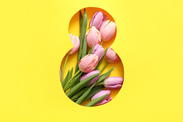 Cut yellow paper in shape of figure 8 with beautiful tulip flowers on color background. International Women's Day celebration