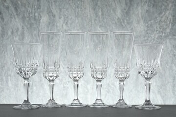 Many empty clean glasses on grey table