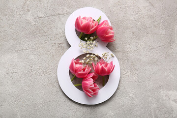 Figure 8 made of paper with beautiful tulips and gypsophila flowers on grey background....