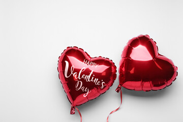 Happy Valentine's day card. Red shiny heart-shaped balloons on white background