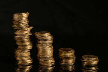 Stacks of coins on black background. Wealth concept