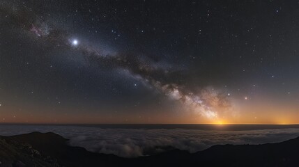 Fototapeta premium Starry night sky with milky way galaxy over mountain horizon, clouds below. Cosmic wonder and astronomy concept