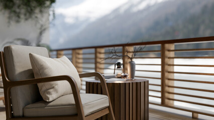 A wooden arm chair with pillow places beside the round table on the balcony with mountain view.