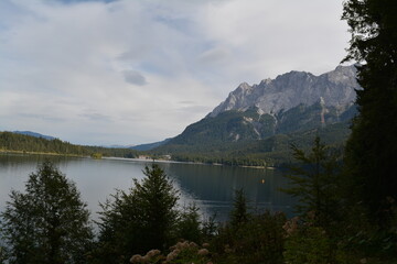 Majestic alpine landscape featuring crystal-clear lakes surrounded by high mountains and dense pine forest. Perfect nature background from the Alps