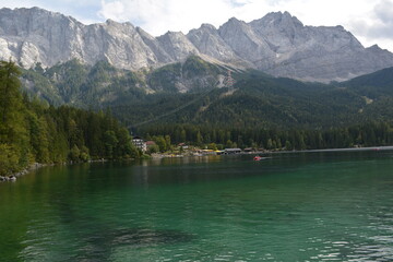 Majestic alpine landscape featuring crystal-clear lakes surrounded by high mountains and dense pine forest. Perfect nature background from the Alps