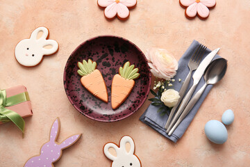 Stylish table setting with sweet cookies, Easter eggs, gift box and beautiful flowers on beige background
