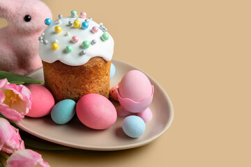 Composition with plate, flowers, Easter eggs and cake on beige background