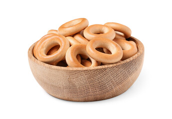 Wooden bowl of tasty bagels on white background