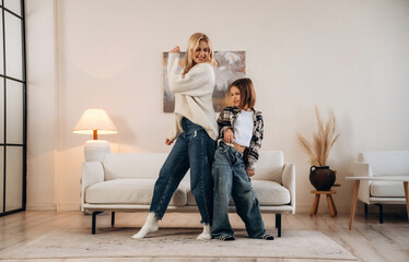 Party, dancing and having fun. Mother and daughter are together in domestic room