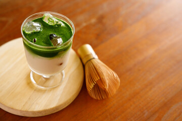 Iced matcha latte, authentic japanese matcha latte drink in a glass.
