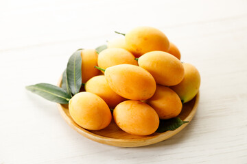 Plum Mango or Marian Plum fruit in wooden tray.