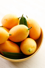 Plum Mango or Marian Plum fruit in wooden tray.