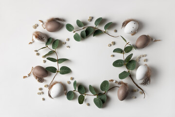 Beautiful spring frame composition with tender eucalyptus, decorative eggs and willow catkins. Happy Easter concept with copy space for your text.