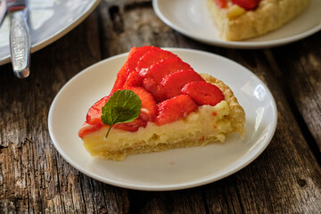 piece of  Tart with custard, strawberries. Chamomile, mint, summer.