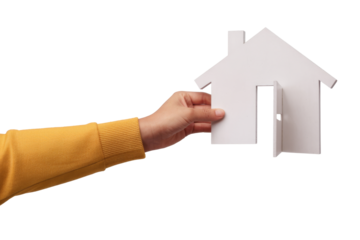hand holds white house cutout on white background