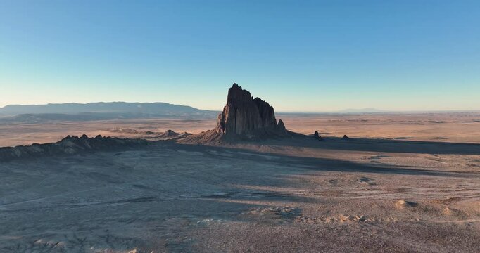 An unworldly high and far, wide-angle aerial shot of the sacred &ldquo;Ship Rock&rdquo;, a massive, monolithic monadnock, towering above the high desert plain of the Navajo Nation, in New Mexico, United States.