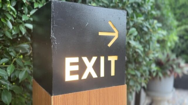 Close-up of an exit sign with an arrow, providing clear directional guidance in a safety-focused setting.
