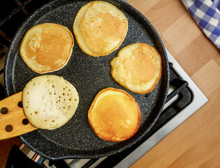 Delicious and Fluffy Pancakes Cooking in a pan