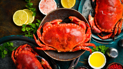 Delicious boiled large crabs with claws, served with lemon, salt and spices. A great appetizer with beer or wine. © Yaruniv-Studio