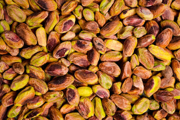 Texture background of peeled pistachios. Close-up of nuts, top view.