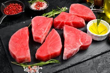 Fresh frozen tuna fillet with spices ready to cook. Top view.