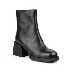 Women's shoes on a white background. Close up of a women's black leather chelsea boots on white background. Footwear for city, urban lifestyle or traveling. Concept of fashion, design and footwear.