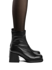 Women's shoes on a white background. Close up of a women's black leather chelsea boots on white background. Footwear for city, urban lifestyle or traveling. Concept of fashion, design and footwear.