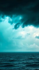 Obraz premium Dynamic sky over calm ocean creates serene backdrop for mobile wallpaper design