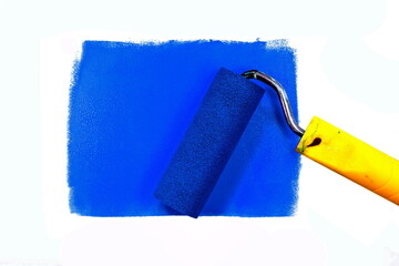 Painting a rough wall with roller. Paint roller leaving stroke of blue color over a rustic background. usable for text and messages. Blue background.