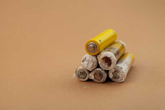 Faulty, oxidized and leaking disposable alkaline batteries. Batteries with corrosive white powder of potassium hydroxide formed often found in forgotten devices and radio-controlled children's toys