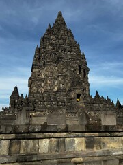 Majestic Prambanan Temple rises against a vibrant blue sky, showcasing the ancient architecture and...