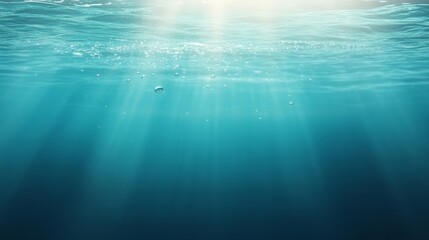 Obraz premium Sunlight Rays Illuminating Calm Ocean Water Below the Surface