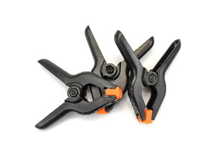 Black plastic clamps, isolated on a white background.