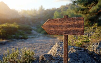 Wooden directional signpost in mountain landscape at sunrise