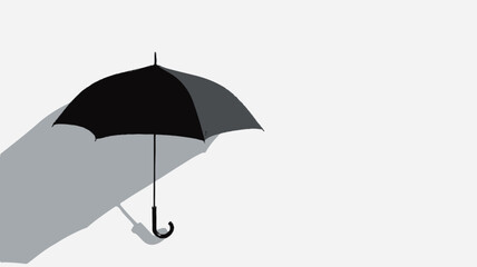 High-angle, close-up view of a closed black umbrella leaning against a plain white wall. The umbrella casts a distinct shadow on the wall. The image is minimalist in style, featuring a stark