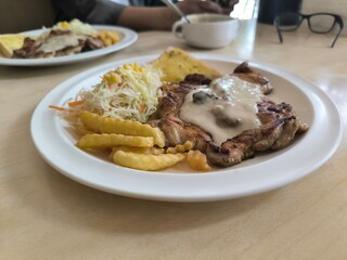 Chicken Steak with Mushroom Cream Sauce french fried and salad delicious food in Thai restuarant