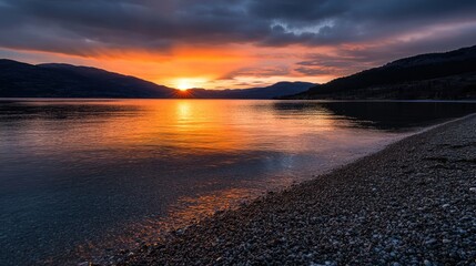 Sunset glow over a tranquil cove, with warm tones reflecting off the water and sand