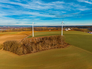 Winter drone view captured in flight near two wind power plants at Kugl near Landau an der Isar,...