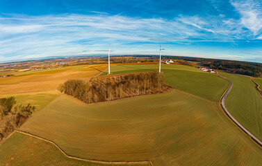 High resolution stitched winter drone panorama captured in flight near two wind power plants at...