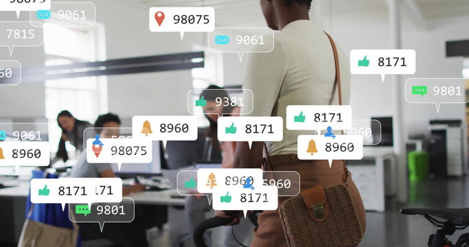 Image of social media icons with numbers over diverse colleagues working in office