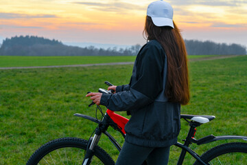 girl on a bicycle against the sky