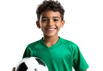  A young boy in a green soccer jersey is smiling and holding a black and white soccer ball against a transparent background