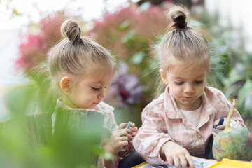 Two girls enthusiastically drawing with colorful pencils, spending time together
