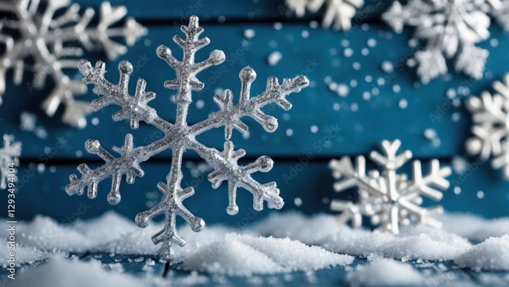 Poster silver snowflakes nestled in artificial snow on a blue wooden background showcasing enchanting chris