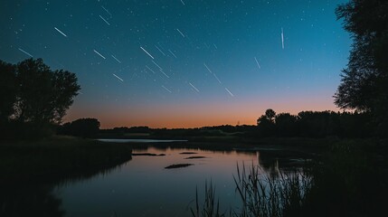 Obraz premium A tranquil river reflecting a sky full of shooting star