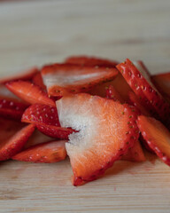 fresh strawberry slices on a cutting board close-up