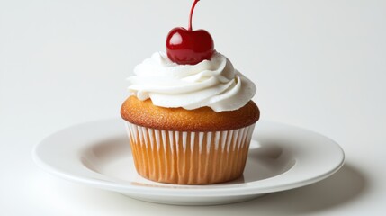 Delicious vanilla cupcake topped with whipped cream and a bright red cherry, perfect treat for dessert lovers and festive occasions, styled on a clean white plate.