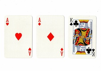A hand of three playing cards isolated on a white background.